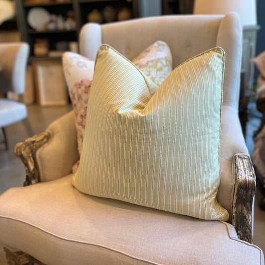 Experience unbeatable comfort with the adorable Penelope Cotton Ticking Stripe Cushion! Featuring a subtle ticking stripe and a playful pastel lime color, this cushion is sure to add a touch of fun to any space. Complete with a feather insert, it's the perfect combination of style and coziness. Front