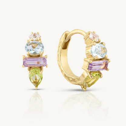Hand-cut gemstone hoops featuring Sky Blue Topaz, Amethyst, and Peridot with Cubic Zirconia accents. Classic claw setting showcases the crystals beautifully. A striking statement piece for any ear.