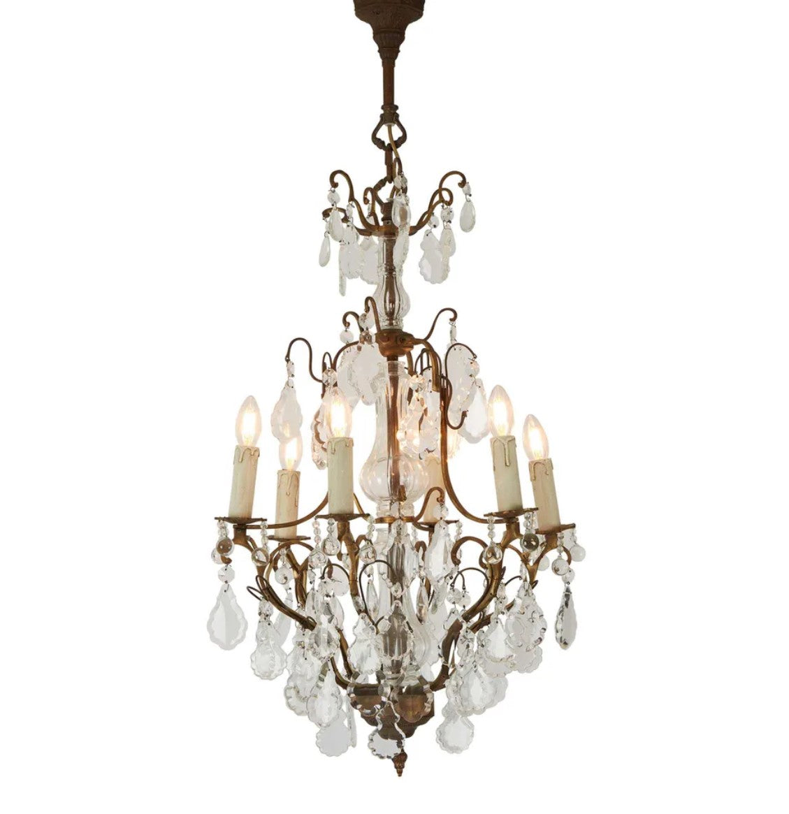 Indulge in timeless elegance with the Lyon Chandelier. This 6-light fixture, crafted from high-quality brass, features a traditional form with graceful elongation.  A stunning focal point for both classic and modern spaces, this exquisite chandelier beautifully combines brass cast iron with sparkling crystal in a truly baroque style. Elevate your interior space with this French classic, the ultimate statement piece in glass and brass.