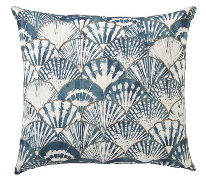 Decorative pillow with blue and white shell pattern on a white background