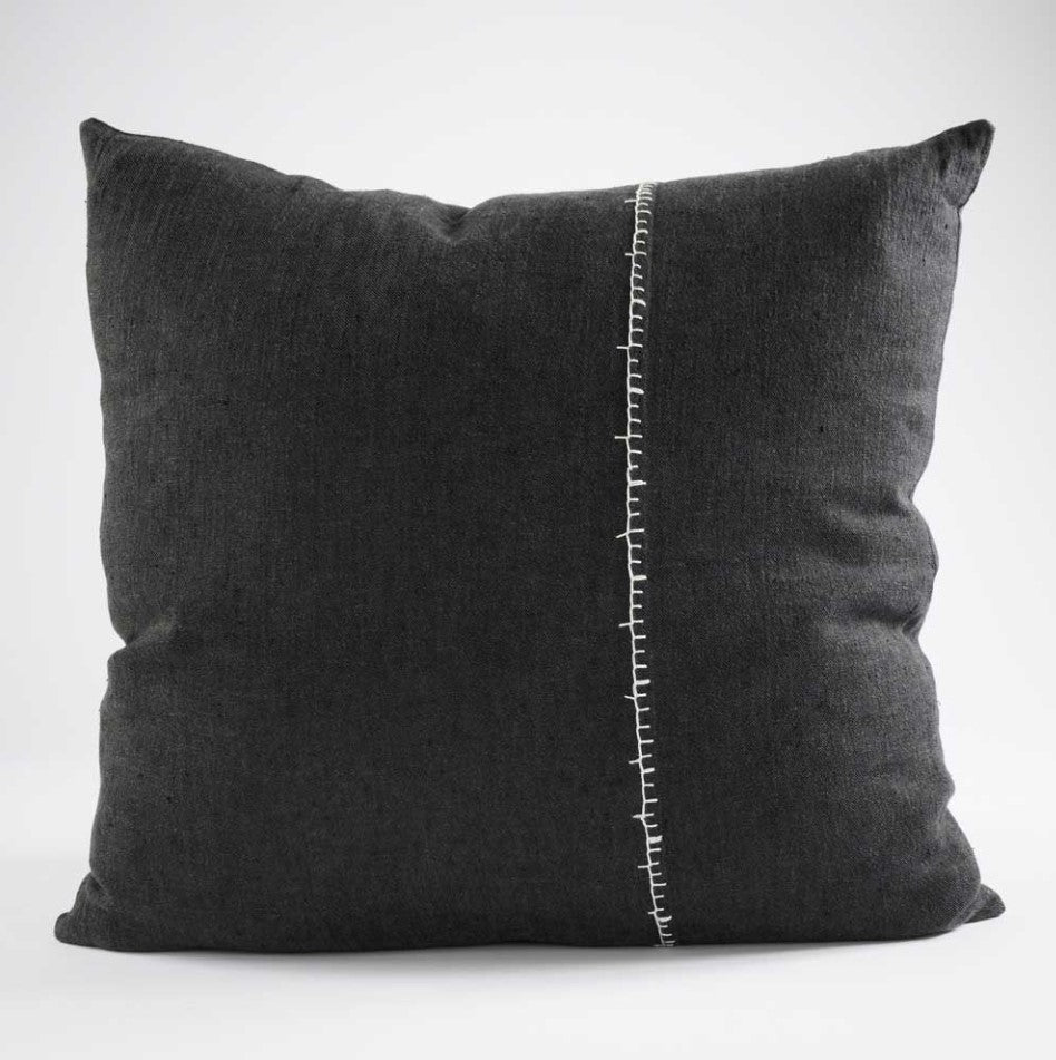 Our Amber Linen Hand-Embroidered Charcoal Cushion 50cm x 50cm was specifically crafted with meticulous detail and casual living in mind. This muted black cushion with its contrast handcrafted blanket stitch adds a stylish touch to any high-traffic area, providing both durability and comfort. Its exclusive plump feather insert guarantees the most comfortable seating experience, while its 100% linen composition ensure quality. OEKO-TEX® and GOTS certified, this cushion is a smart addition to any space. Front.