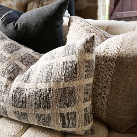 An embodiment of understated elegance, the Chloe Linen Criss-Cross Lumbar Cushion is inspired by the cobbles stones of Greece, featuring a luxe weave pattern that captures the eye. Add the matching throw and other pieces from our collection to create a beautiful ensemble, or let the cushion stand on its own. Filled with the exclusive, ultra-comfortable plump feather insert , crafted from linen/cotton yarn dyed check and is OEKO-TEX® and GOTS certified. Side styled.