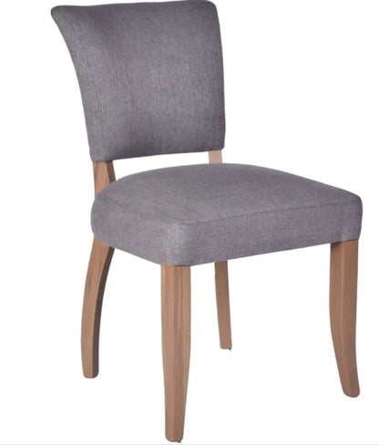 The Chelsea Dining Chair is constructed with a grey linen finish and features stud detailing on the back for a sophisticated, yet comfortable aesthetic. Front