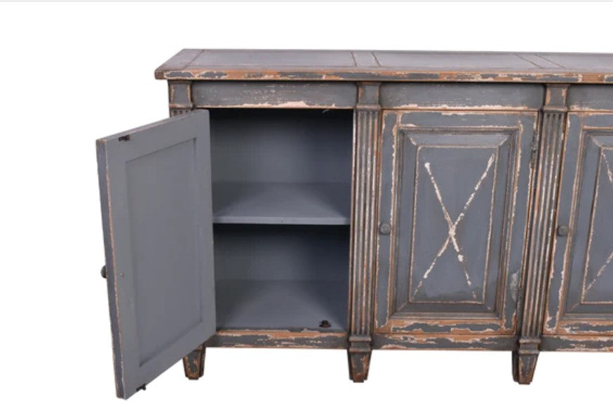 Meticulously crafted from reclaimed timber and adorned with a distressed blue paint finish, this one-of-a-kind sideboard adds versatility to any space. Whether in a dining room, bedroom, or elegant hallway, its three doors offer ample storage. Detail