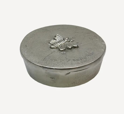 This stunning Round Silver Box is adorned with a beautiful bee design on the lid, making it the perfect place to store life's little treasures. Use it to hold jewellery, coins, or other small mementos. The lid keeps contents secure, making it ideal for a bedroom dresser or bedside table.