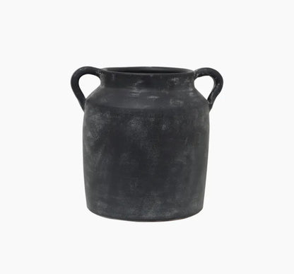 Transform your space with this Oliver Black Distressed Terracotta Pot, featuring a timeless and rustic charm that exudes character and elegance. The black and white distressed finish and small handles make it perfect for styling on a coffee table, shelf, or table. Get ready to add a touch of sophistication to your home!