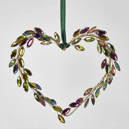 Experience the beauty of this charming hanging heart ornament! Adorned with soft pink, purple and green crystals, it adds a touch of elegance and sparkle to your Christmas tree. Use the attached green ribbon to easily hang this stunning piece and complete your tree styling.