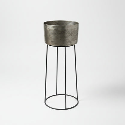 Add a touch of elegance to your gatherings with the Amoy Standing Wine Bucket Large. Its sleek black iron base and antique silver bucket, which can hold up to 4 bottles, make for a convenient and stylish way to serve your favourite wines.