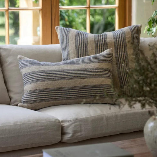 Transform any room into a classic French farmhouse with the Audry Heavy linen Textured Multi Stripe Navy &amp; Natural Cushion. Whether on a chair, sofa, or bed, this cushion exudes elegance and comfort with its plush feather insert.