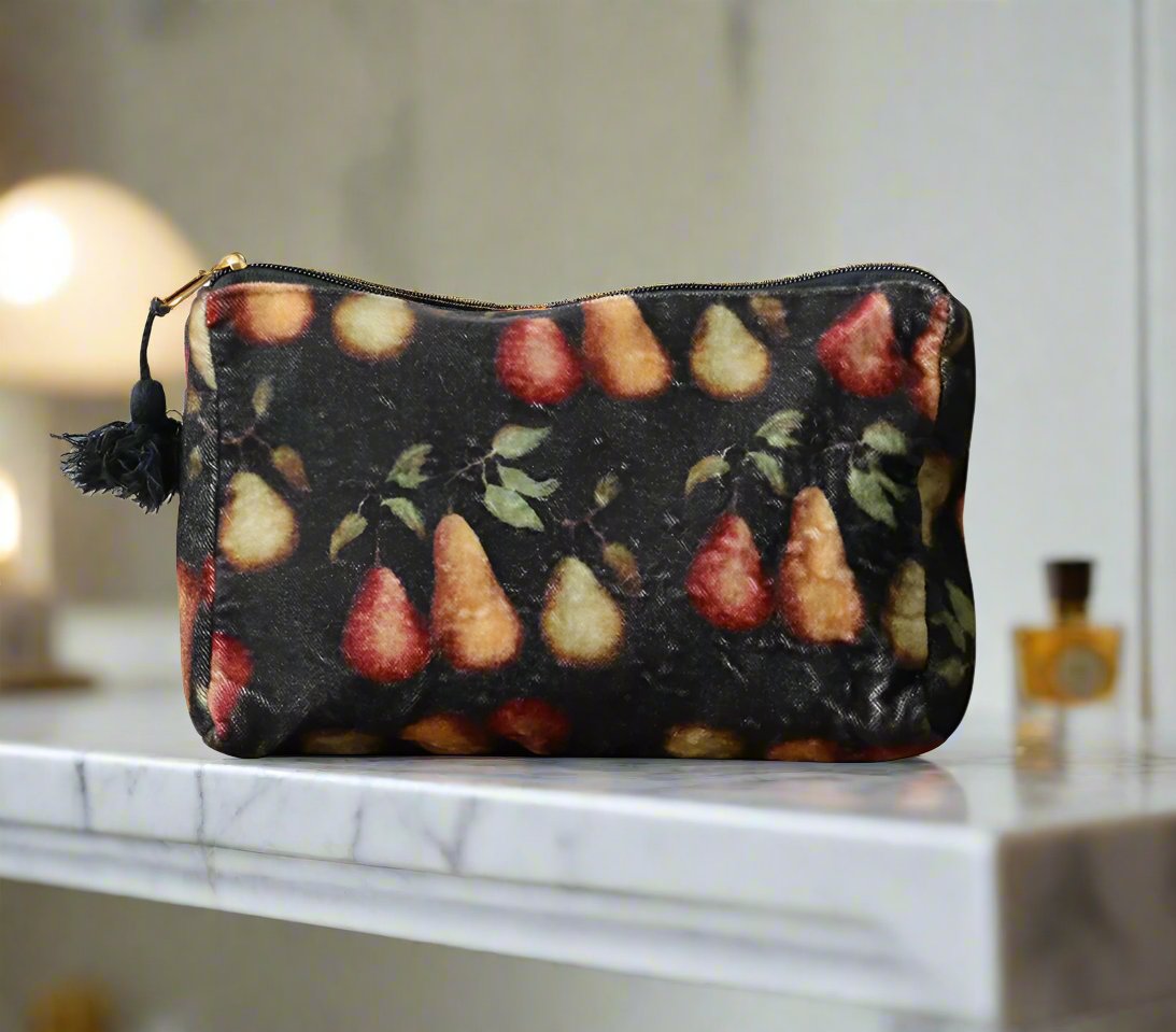 The Raphael Pear Vintaged Velvet Cosmetic Bag features the work of a talented New Zealand artist. This bag perfectly captures the allure of luxurious shades of pears against a deep, moody backdrop. Its convenient zipper makes it a must-have for both organizing cosmetics and accessorising with flair. Made from a blend of soft cotton and plush velvet.