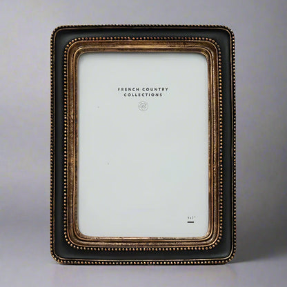This elegant Beaded Black &amp; Gold Photo Frame showcases a classic black and gold beaded pattern, bringing a sense of warmth and sophistication to any space. Its timeless design perfectly enhances your treasured photos or artwork, making every memory stand out beautifully.
