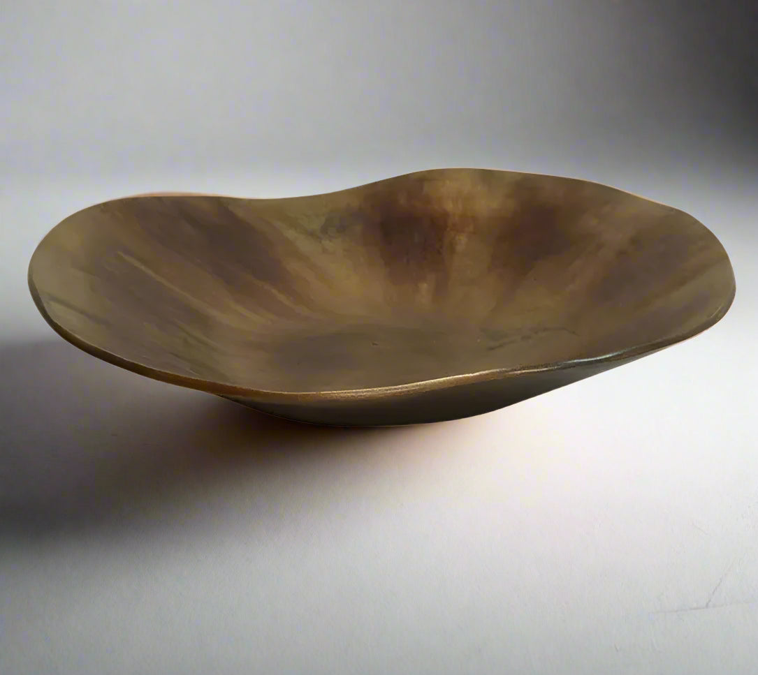 The Alman Decorative Bowl blends rustic appeal with graceful contours, presenting a one-of-a-kind design that makes a statement on tables, consoles, bookcases, or sideboards. Its elegant free-form shape, highlighted by a burnt copper finish, brings a distinctive and captivating element to your interior. Made from aluminium, this bowl is a bold decorative accent that elevates the style of any space with its artistic flair.