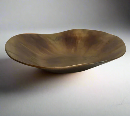 The Alman Decorative Bowl blends rustic appeal with graceful contours, presenting a one-of-a-kind design that makes a statement on tables, consoles, bookcases, or sideboards. Its elegant free-form shape, highlighted by a burnt copper finish, brings a distinctive and captivating element to your interior. Made from aluminium, this bowl is a bold decorative accent that elevates the style of any space with its artistic flair.
