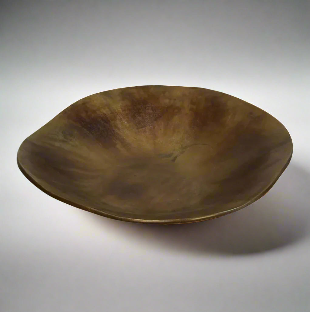 The Alman Decorative Bowl blends rustic appeal with graceful contours, presenting a one-of-a-kind design that makes a statement on tables, consoles, bookcases, or sideboards. Its elegant free-form shape, highlighted by a burnt copper finish, brings a distinctive and captivating element to your interior. Made from aluminium, this bowl is a bold decorative accent that elevates the style of any space with its artistic flair.
