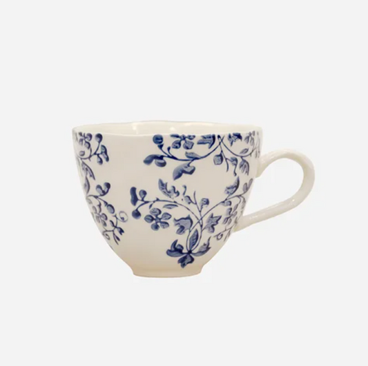 White mug with blue floral pattern on a white background