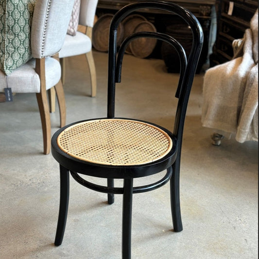 Designed with a black-finished teak frame, the Alam Rattan Chair has a simple arched back designed with and a natural woven seat.