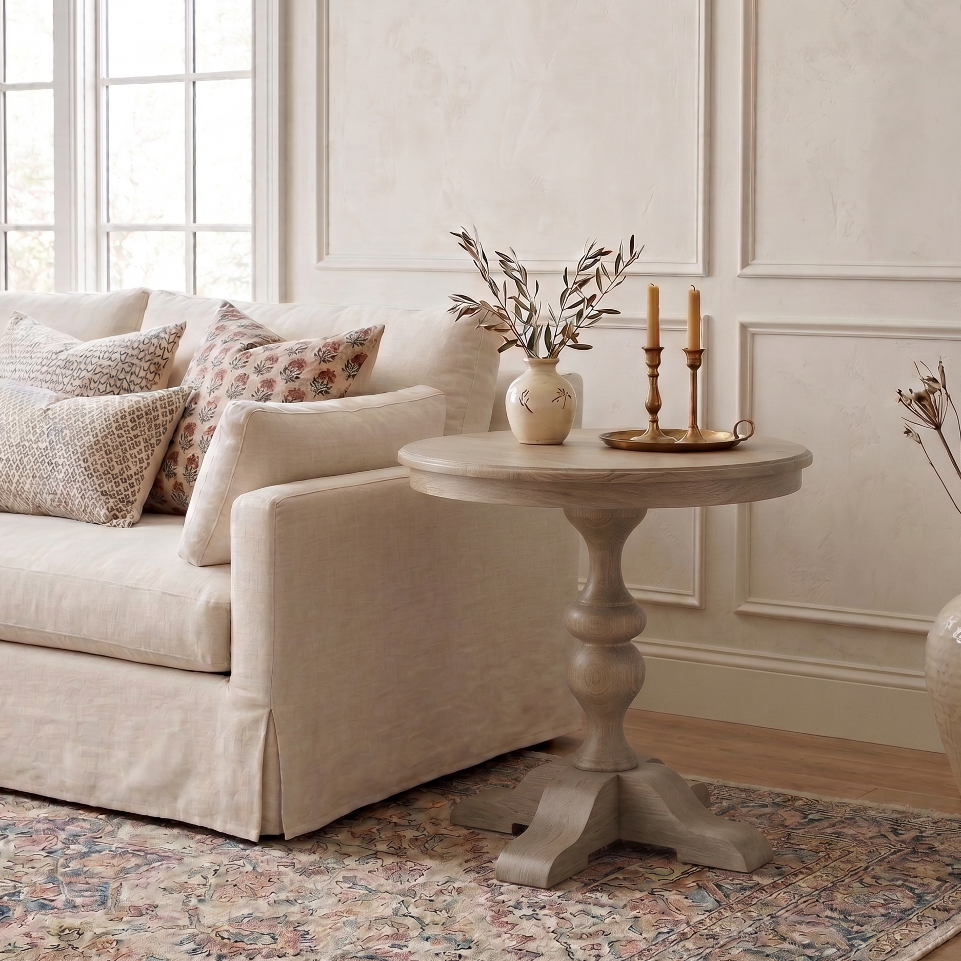Living room with beige sofa, decorative table, and vases.