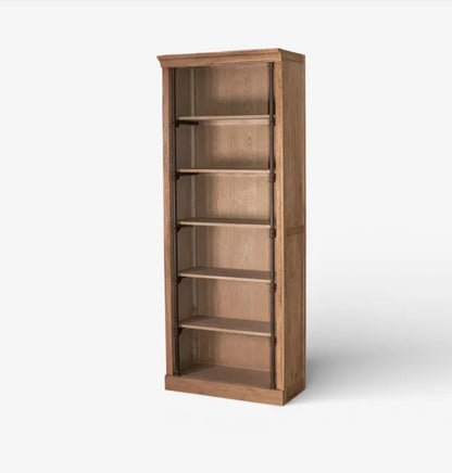 A tall, narrow wooden bookcase with five open shelves, shown at a slight angle on a light gray background.