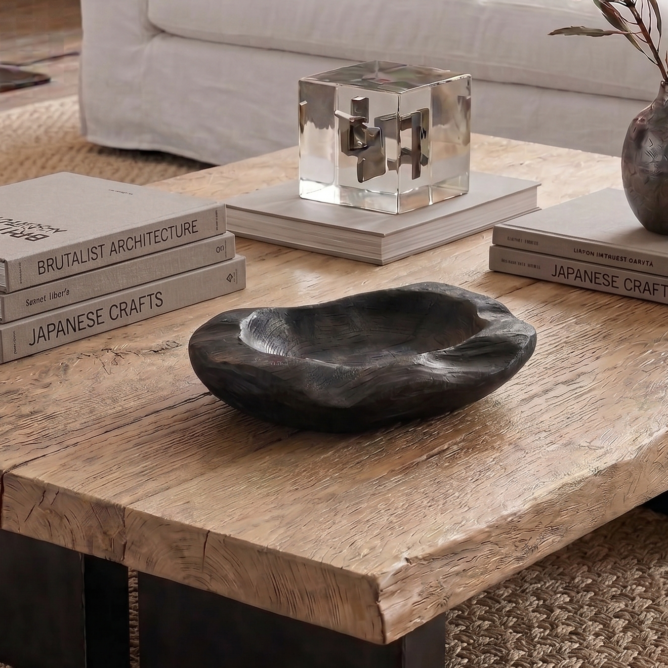 Wooden coffee table with decorative items in a living room setting