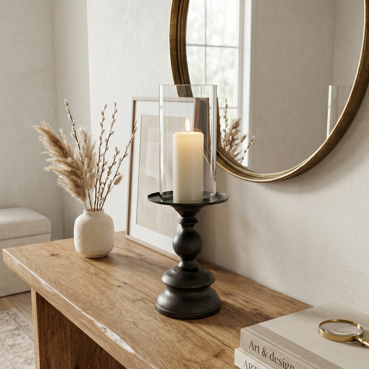 Wooden console table with decorative items including a candle, books, and a mirror.