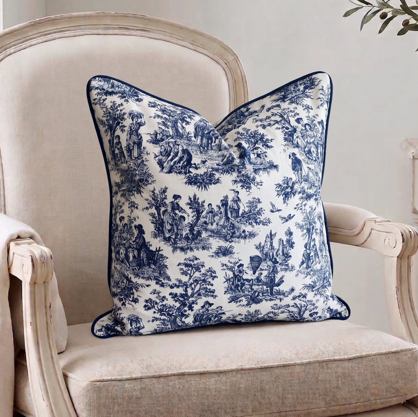 Decorative blue and white pillow on a beige armchair