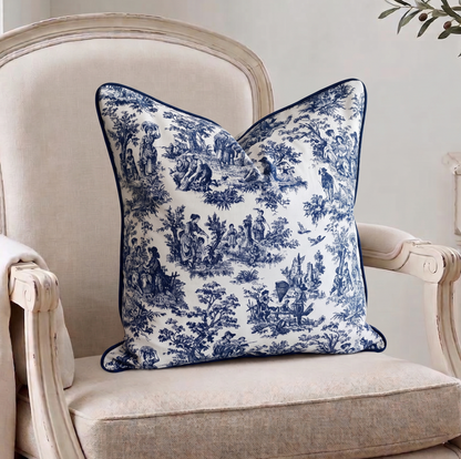 Decorative blue and white pillow on a beige armchair