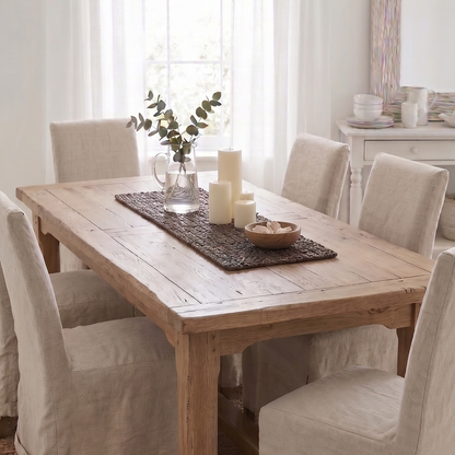 Dining room with wooden table and chairs in a bright room.