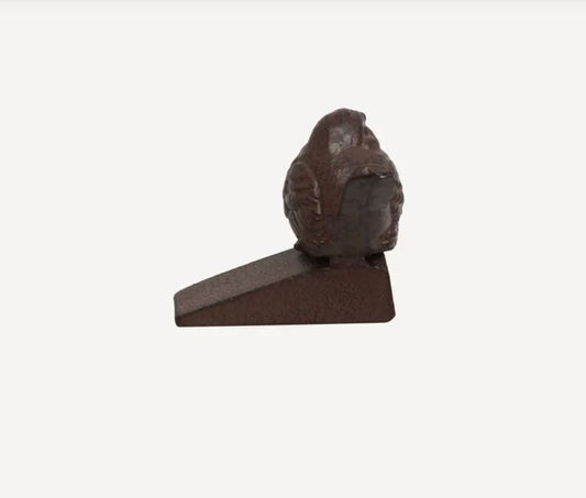 Decorative bird-shaped door stopper on a white background