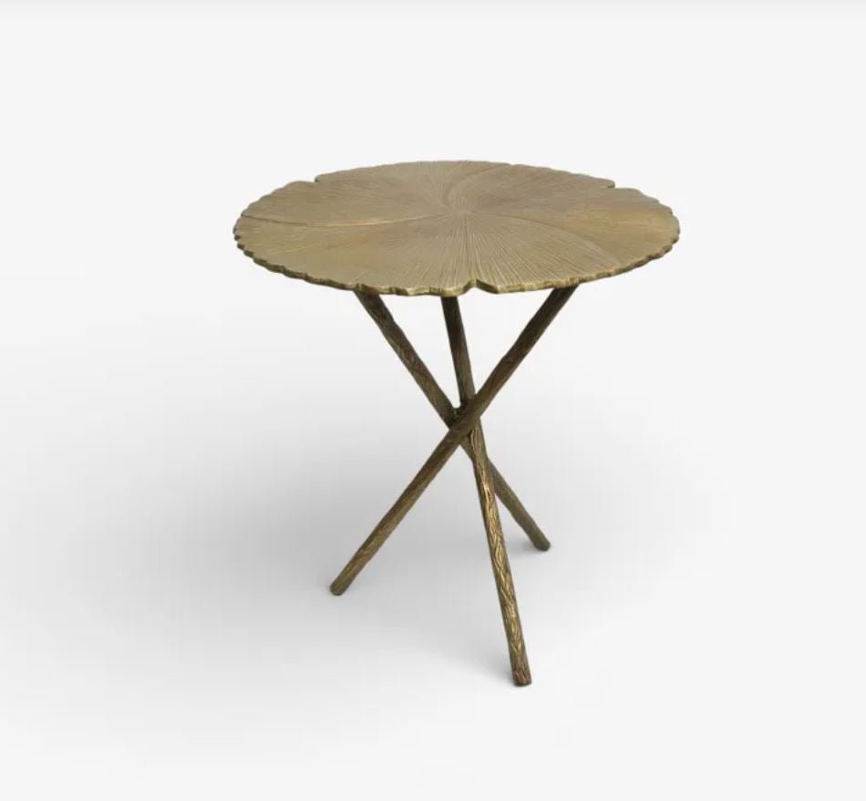Decorative side table with a leaf-like design on a white background