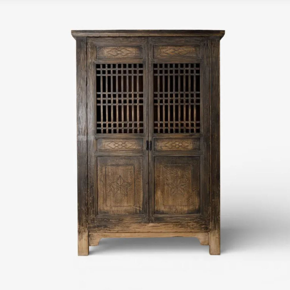 Wooden cabinet with intricate designs on a white background