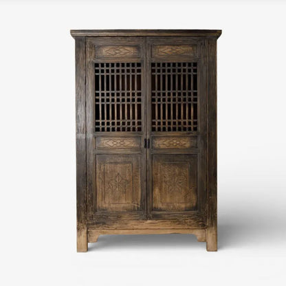 Wooden cabinet with intricate designs on a white background