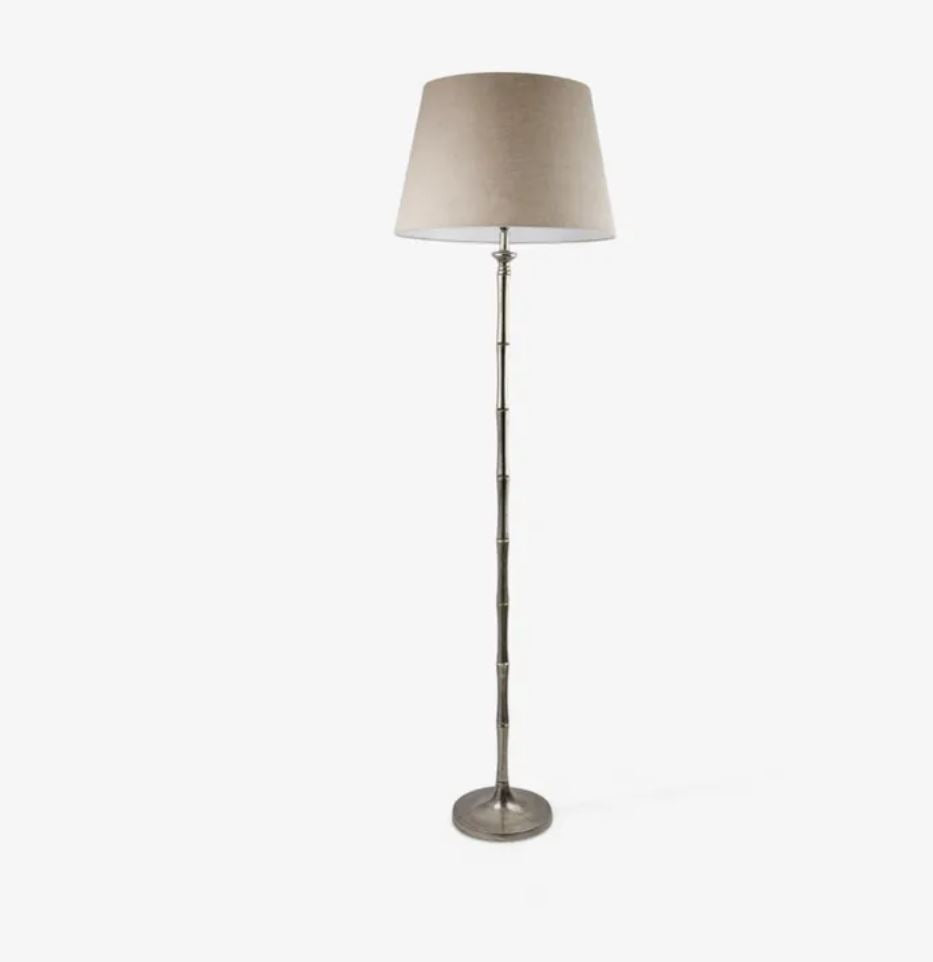 Floor lamp with a beige shade on a white background