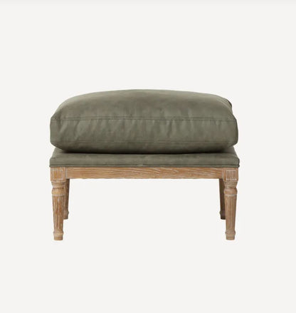 A rustic wooden bench with a thick, cushioned olive green upholstered seat and backrest, shown against a plain light gray background.