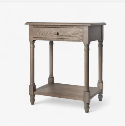 Wooden side table with a drawer on a white background