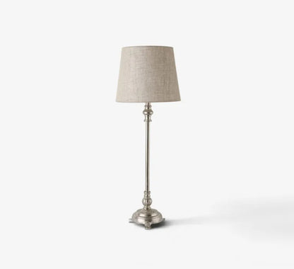 Table lamp with a beige shade on a white background