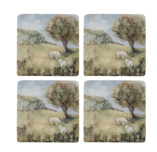Set of four coasters with a scenic design of sheep and trees on grassy hills.