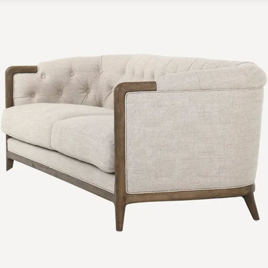 Beige sofa with wooden armrests on a white background