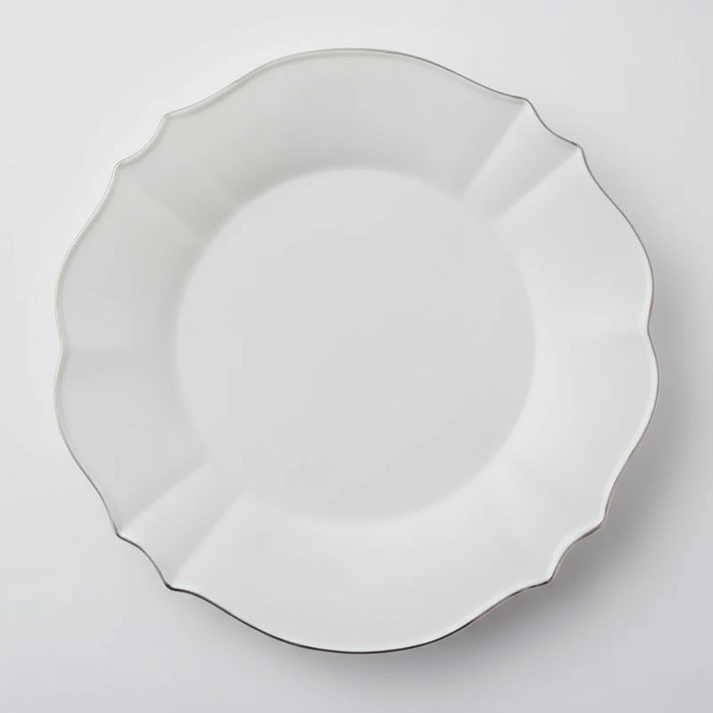 Elevate your dining experience with the Vienna Stoneware Dinner Plate, featuring a timeless scalloped design that adds a touch of elegance to every meal. Crafted for durability and style, this plate brings a refined, formal atmosphere to your table, perfect for both special occasions and everyday sophistication.