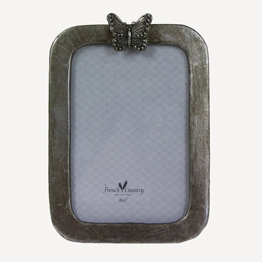 Transform your precious memories into stunning displays with the Butterfly Photo Frame. This frame features an elegant antique silver design with a regal butterfly perched on top, adding a touch of elegance to any room.

Dimensions: 12.5cmL x 1cmW x 17.5cmH