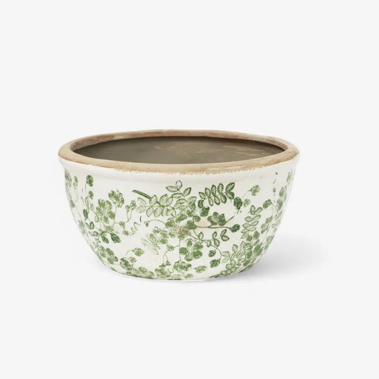 Ceramic bowl with green floral pattern on a white background