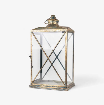 The Calypso Lanterns feature a graceful shape and an aged gold finish that add a cosy, sophisticated touch to any space. It's curved, open structure beautifully diffuses soft ambient light while enhancing your décor with elegance and height. Perfect for layering light indoors or outdoors, these lanterns look stunning on console tables, verandahs, or dining areas, creating a warm and inviting atmosphere.