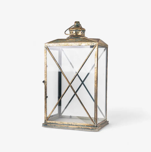 The Calypso Lanterns feature a graceful shape and an aged gold finish that add a cosy, sophisticated touch to any space. It's curved, open structure beautifully diffuses soft ambient light while enhancing your décor with elegance and height. Perfect for layering light indoors or outdoors, these lanterns look stunning on console tables, verandahs, or dining areas, creating a warm and inviting atmosphere.