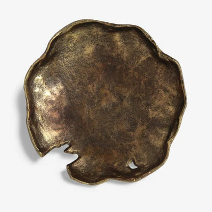Bronze-colored decorative object on a white background
