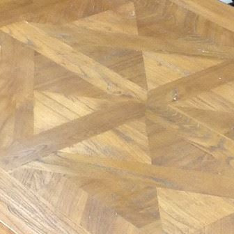 Wooden table with a parquet pattern in an indoor setting