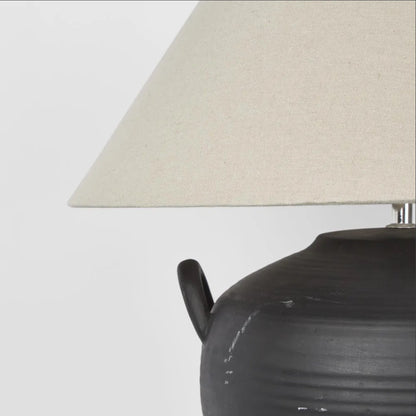 Experience the versatile charm of the Camille Black Table Lamp &amp; Shade, expertly crafted from ceramics. Perfect for any setting, this piece will add a touch of elegance and functionality to your space.

Dimensions: L 46cm W 46cm H 48cm&nbsp;