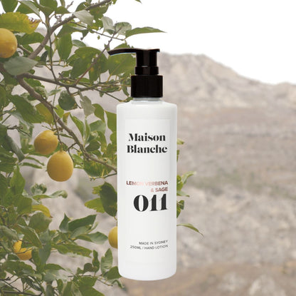 Maison Blanche hand lotion bottle with lemon tree in the background