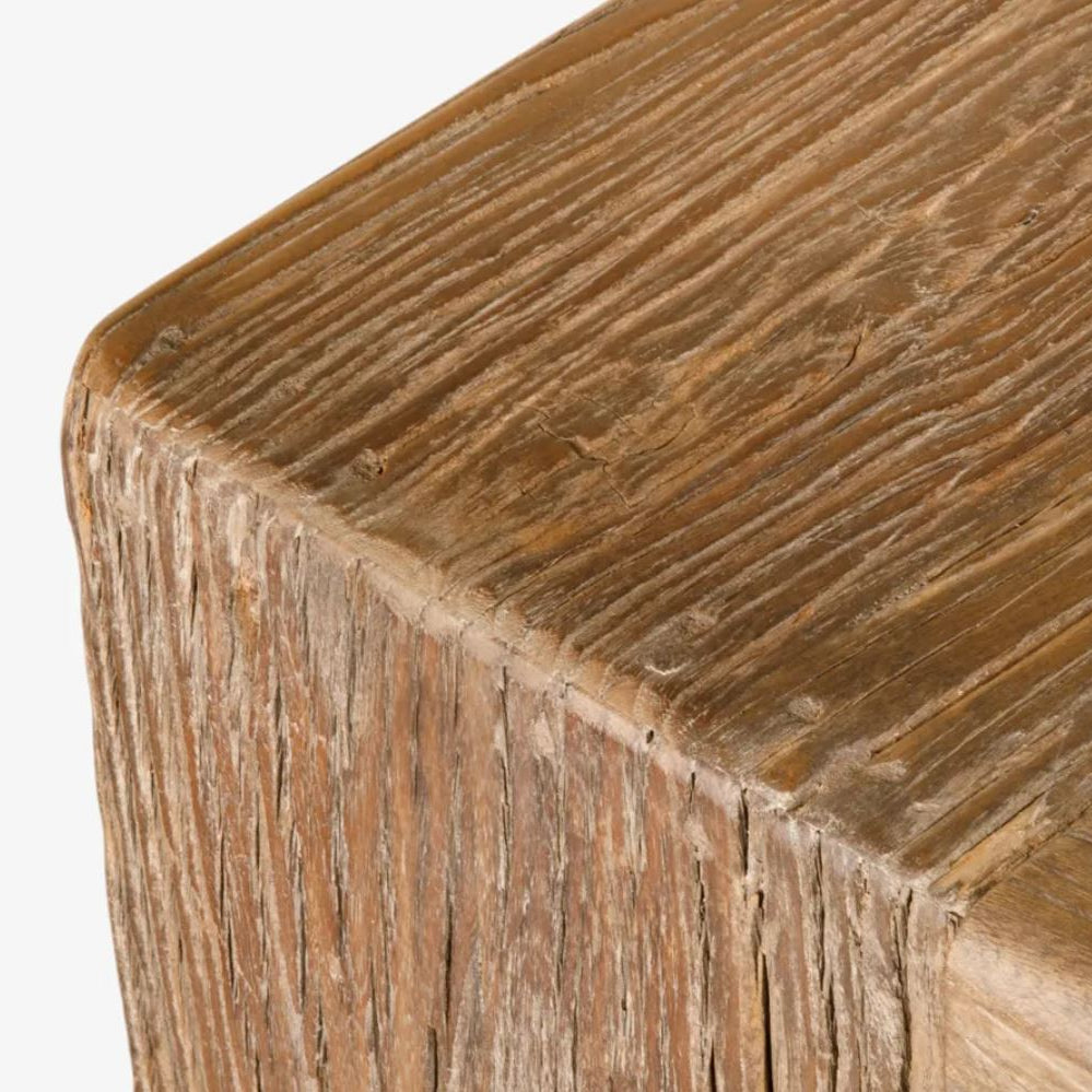 Close-up detail of a rustic wooden furniture piece showing the top surface and thick, textured side edge with natural wood grain.