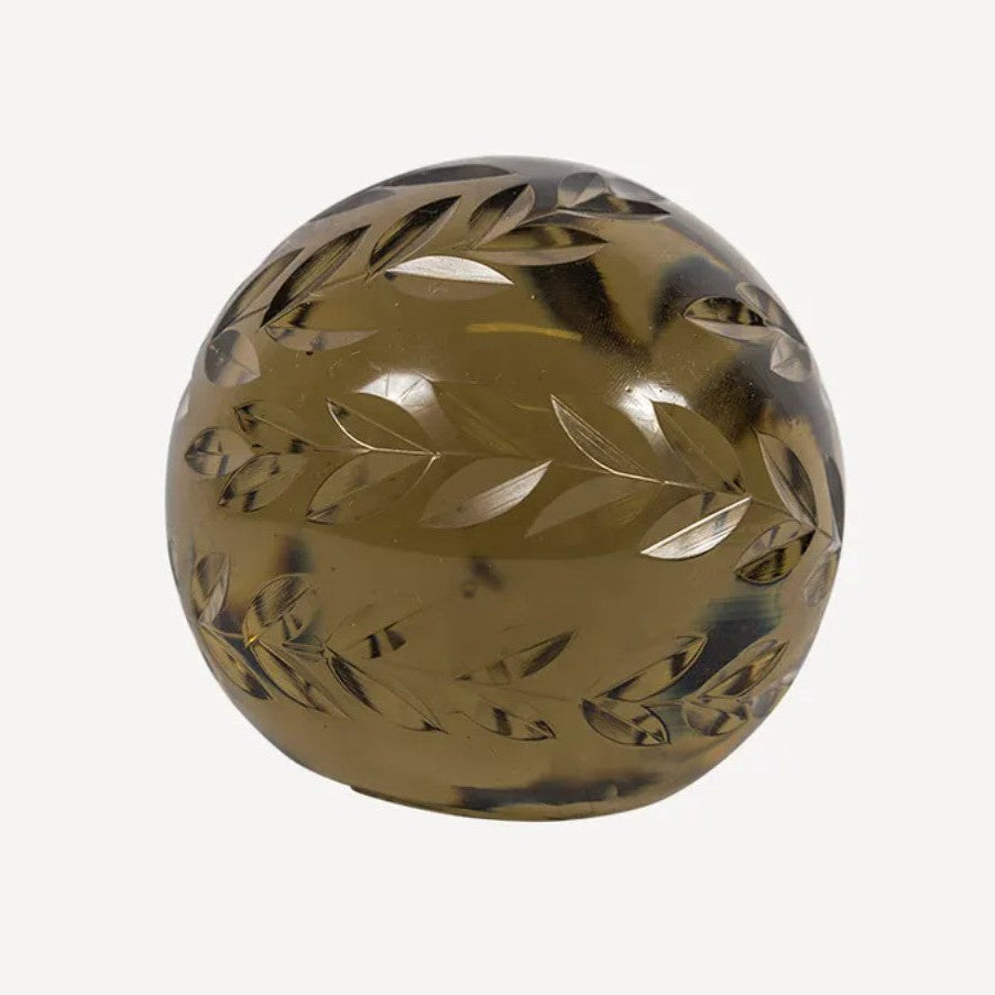 Decorative sphere with leaf patterns on a white background