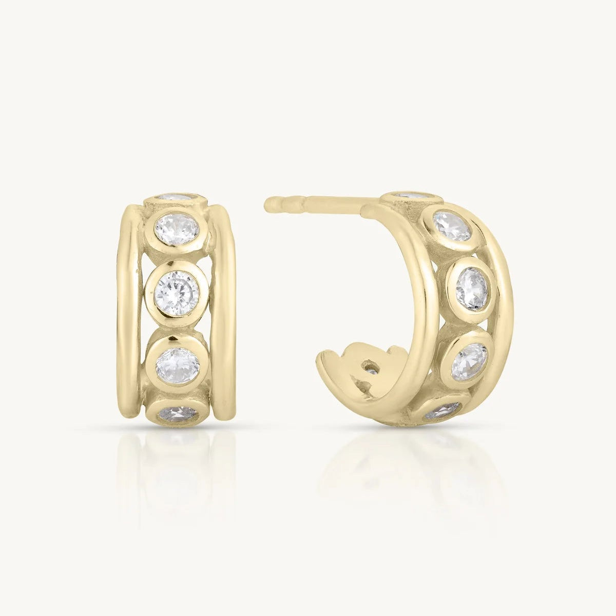 Gold hoop earrings with embedded stones on a white background