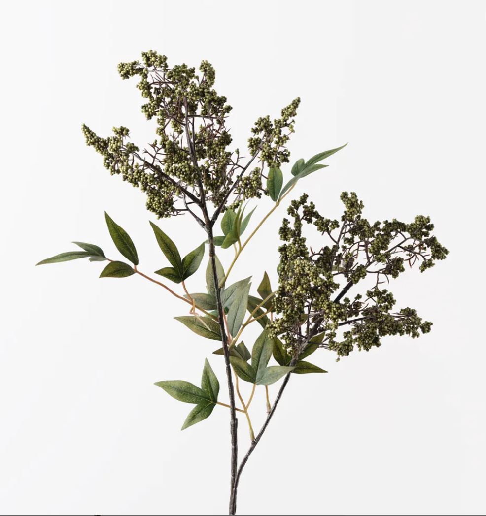 Artificial plant branch with green leaves and buds on a white background